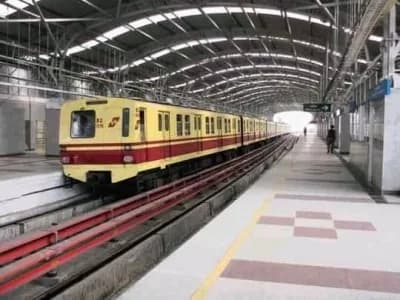 A yellow and red train sits at a covered metro station platform.