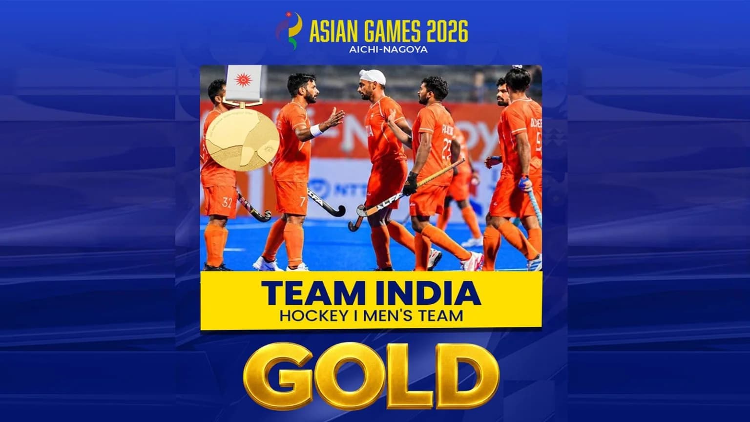 Team India men's hockey players in orange uniforms celebrating their gold medal win.