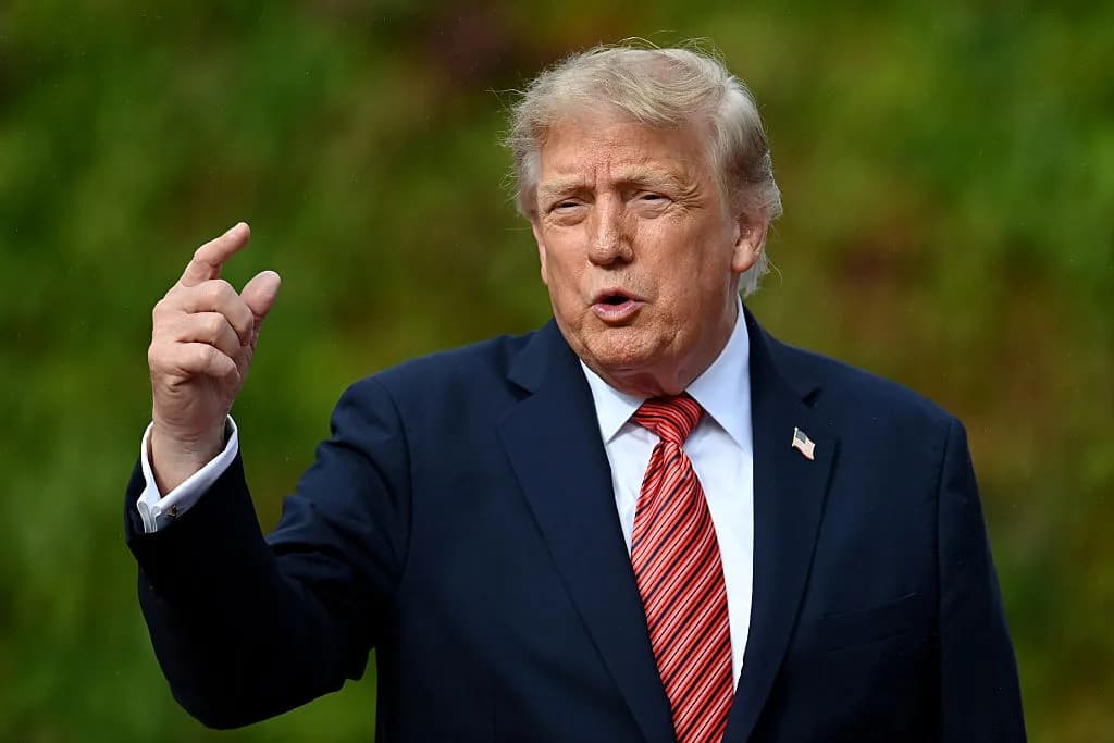 Donald Trump gestures with his right hand while speaking outdoors.